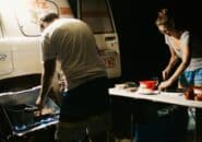 Couple cooking dinner at a 4WD campsite under the stars during a Kimberley night tour.