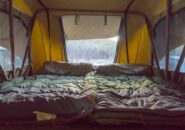 Interior view of spacious rooftop tent with two sleeping bags set up on a Kimberley camping tour.